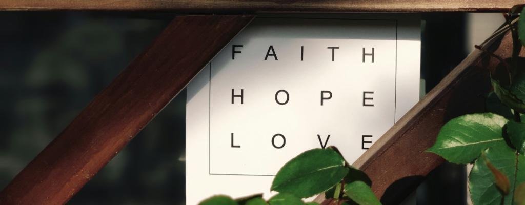 Faith Apparel & Gifts, Faith Hope Love sign surrounded by wood trellis and ivy